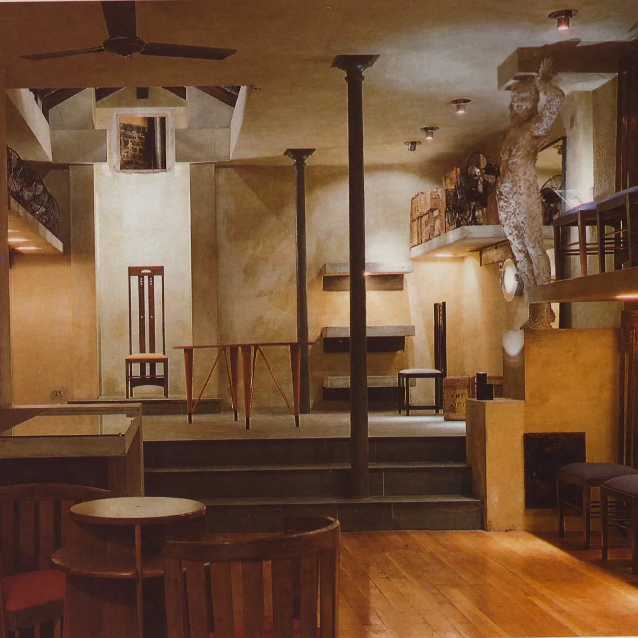 Freud basement bar interior with wooden tables and sculpture