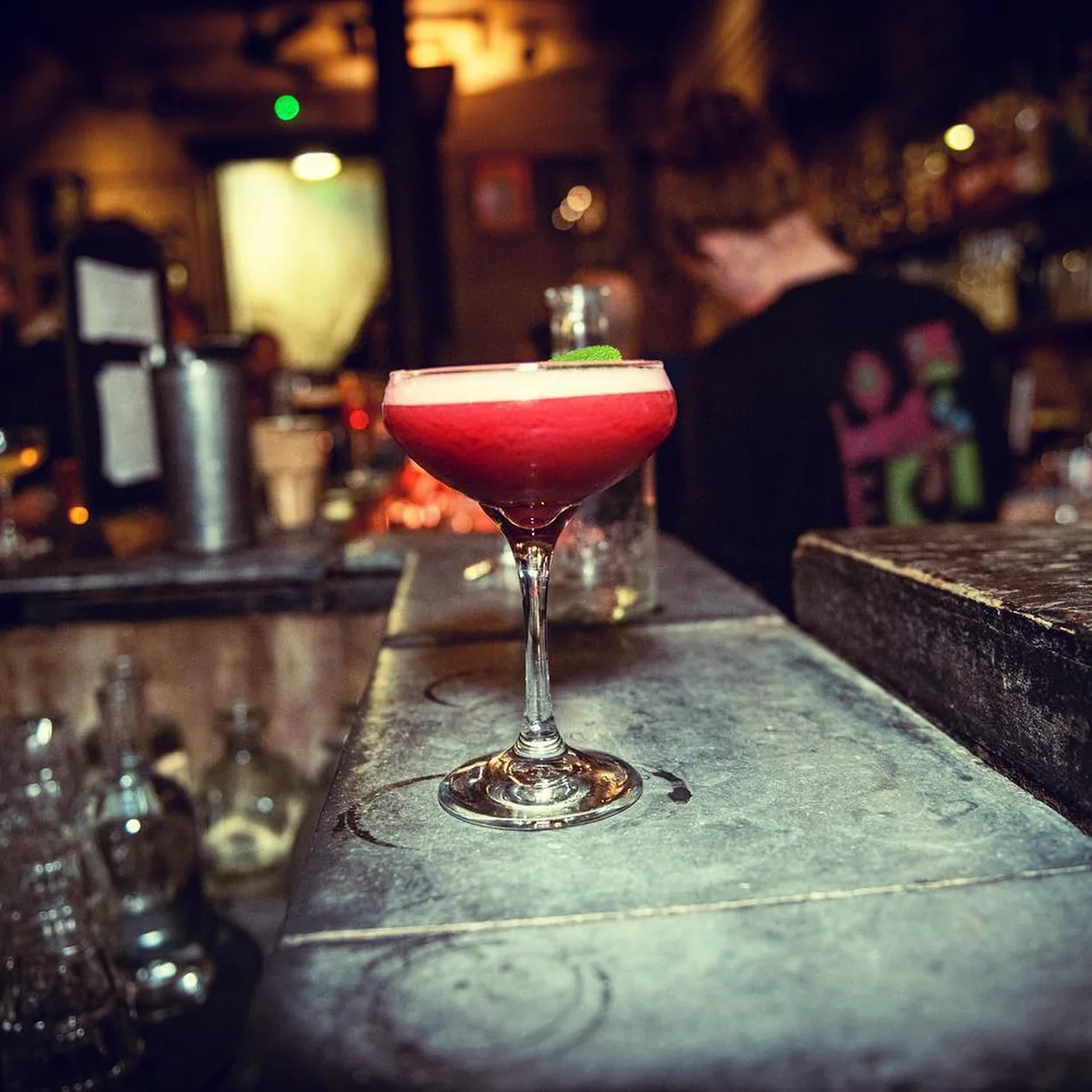 Freud red cocktail in a coupe on the stone bar