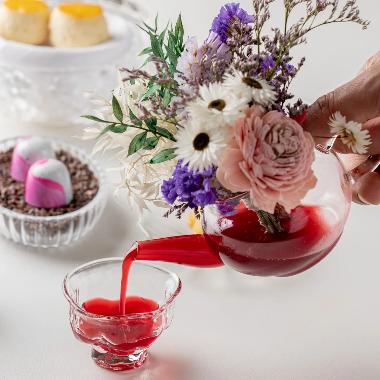 Frog by Adam Handling drinks pairing poured beside fresh flowers