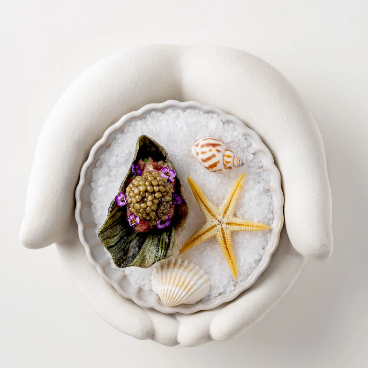 Frog by Adam Handling seafood course served on salt in a sculpted bowl