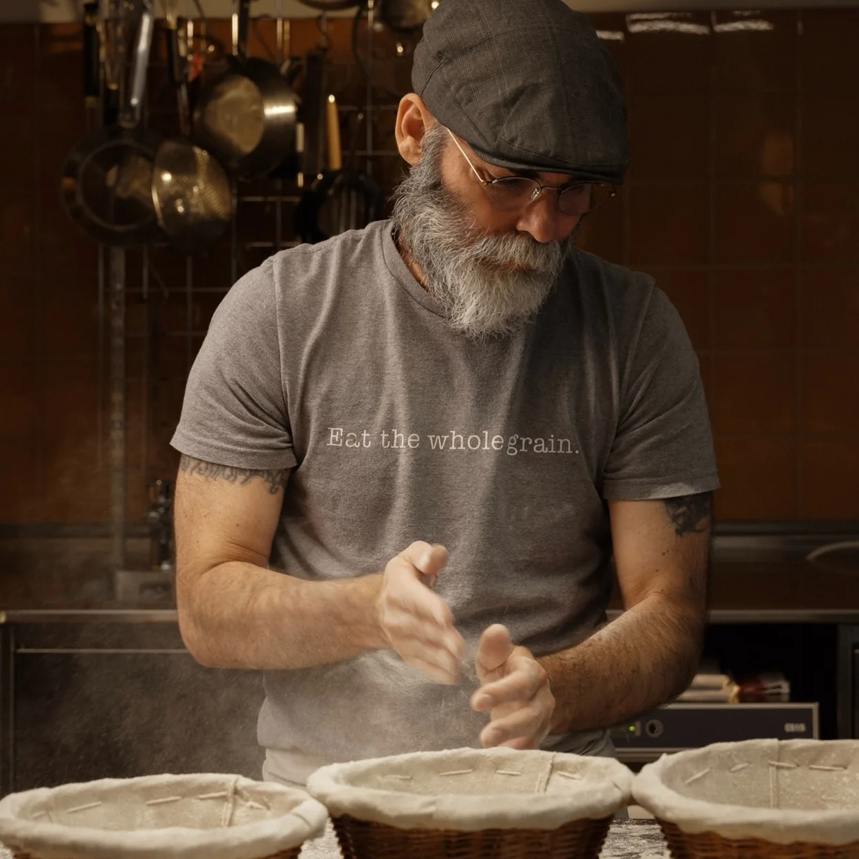 GAIL's Bakery baker shaping dough beside proving baskets