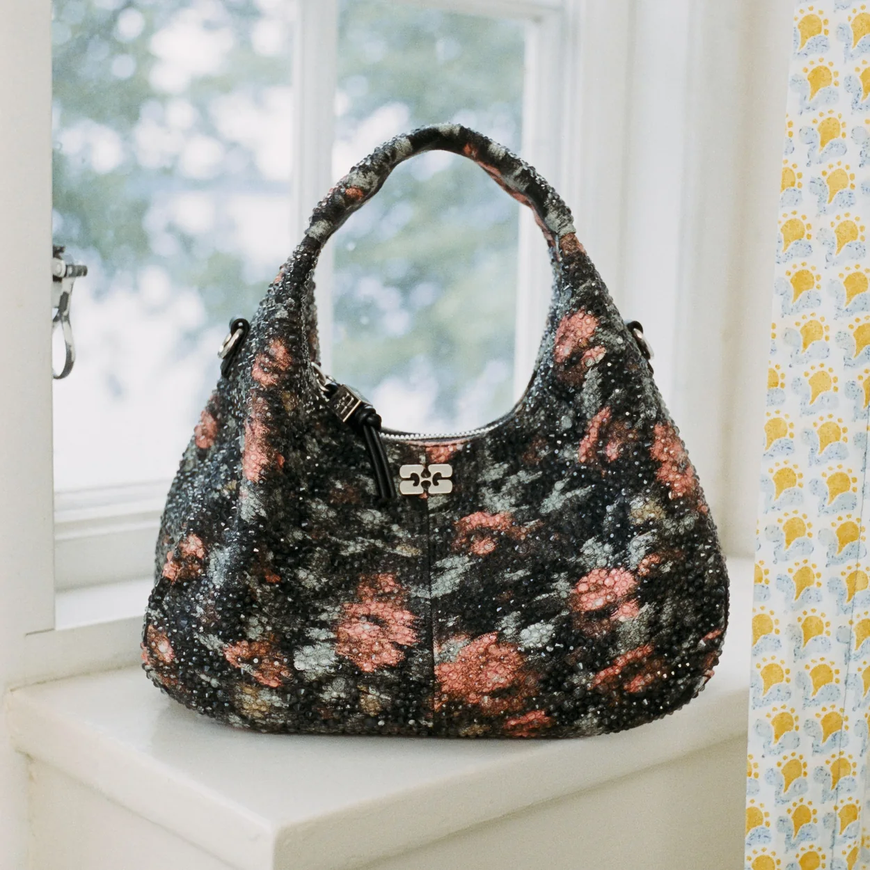 GANNI floral print hobo bag on a windowsill