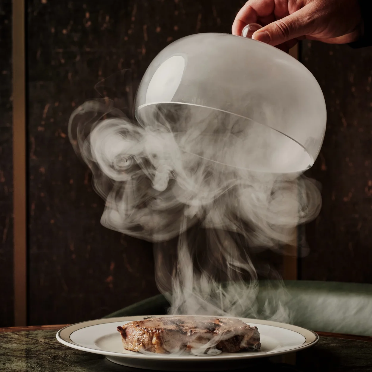 Gaucho Covent Garden smoked dish revealed from under a glass cloche