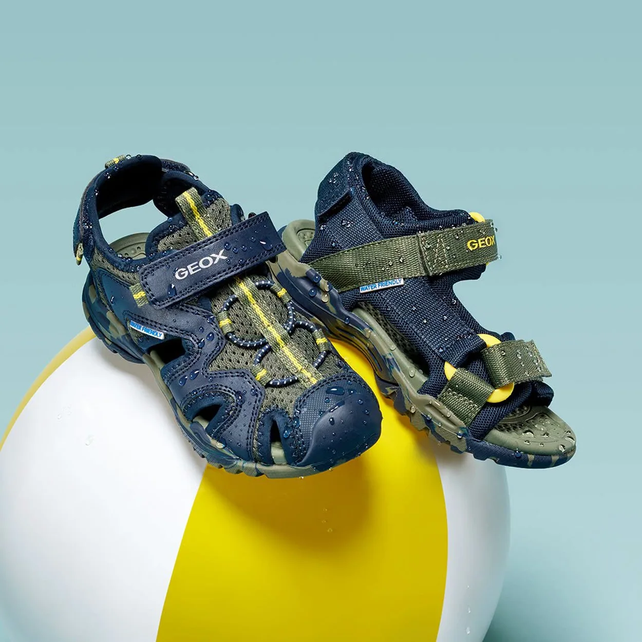 Geox navy and yellow kids' closed-toe sandals on a beach ball