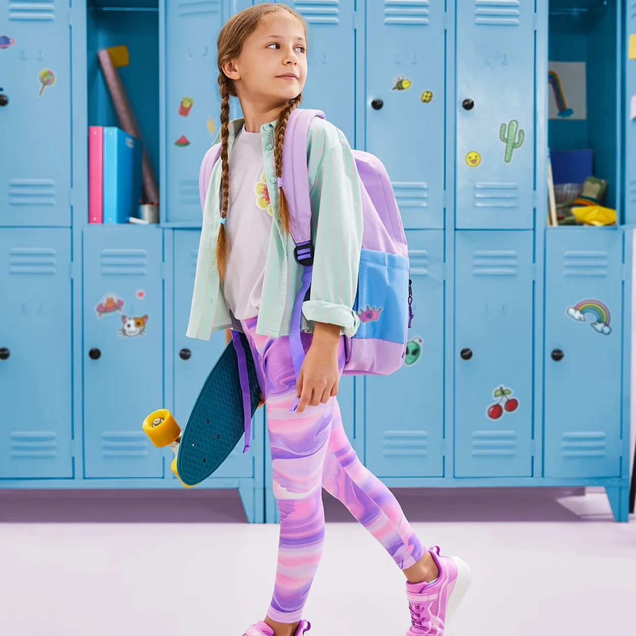 Geox pink trainers worn by a girl with a rucksack beside school lockers