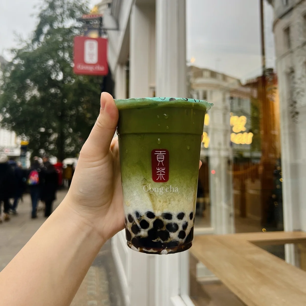 Gong Cha matcha milk tea with pearls held outside the shop on Garrick Street
