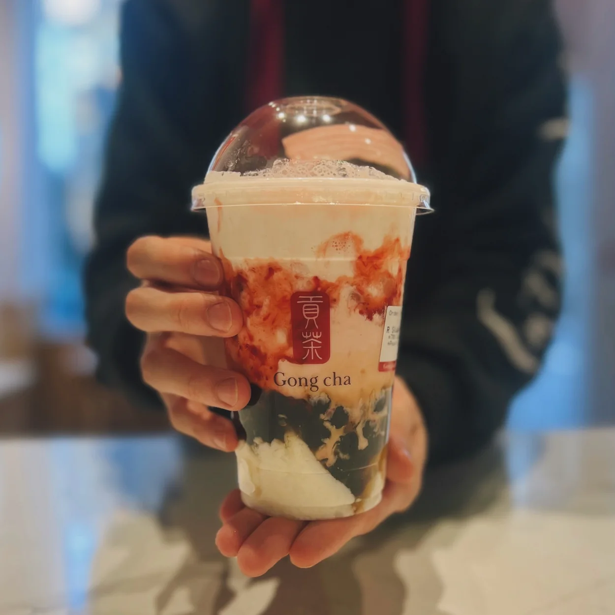 Gong Cha strawberry milk tea in a domed cup