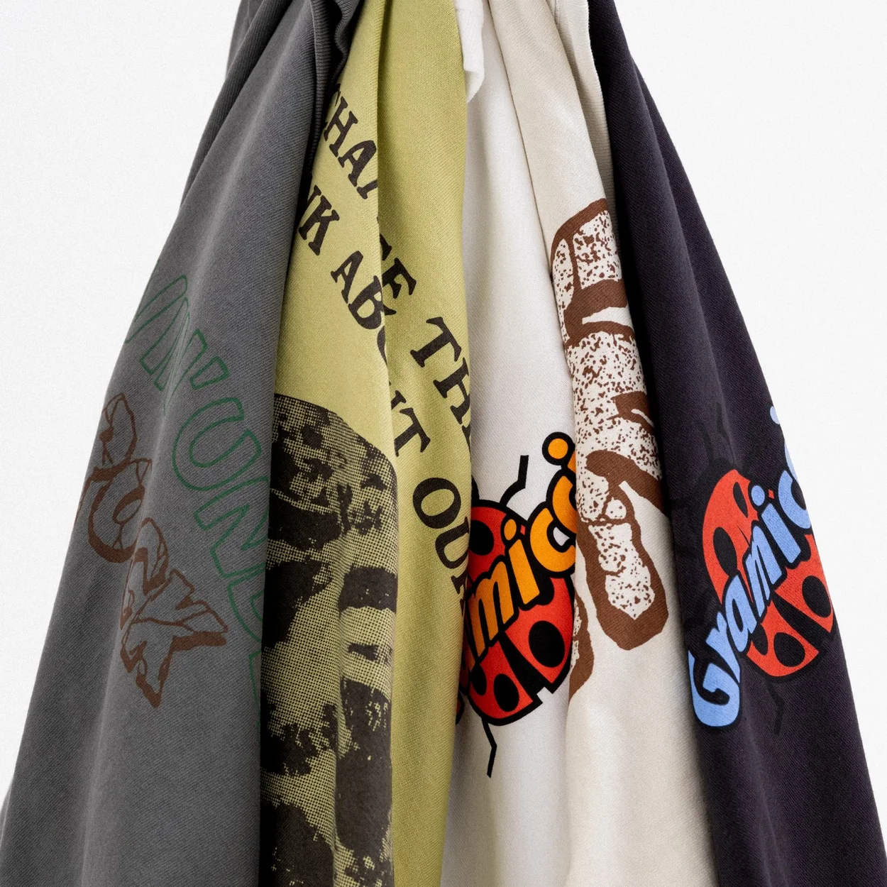 Gramicci graphic T-shirts on hangers