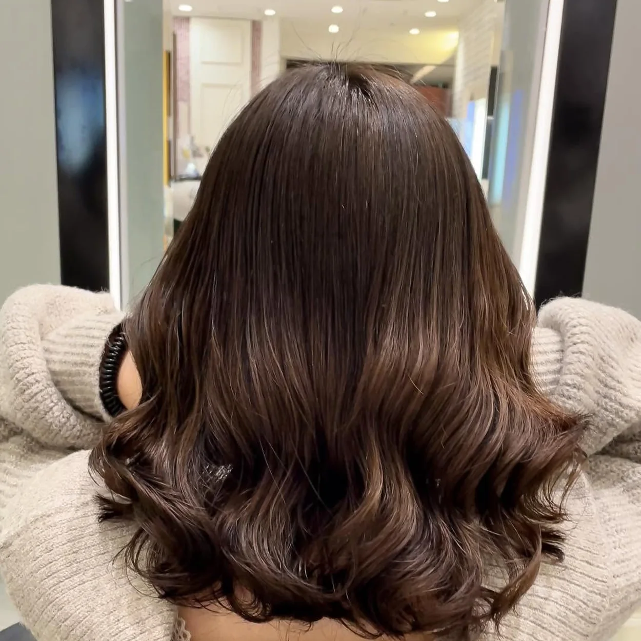 Hayato London glossy brown waves styled in the salon chair