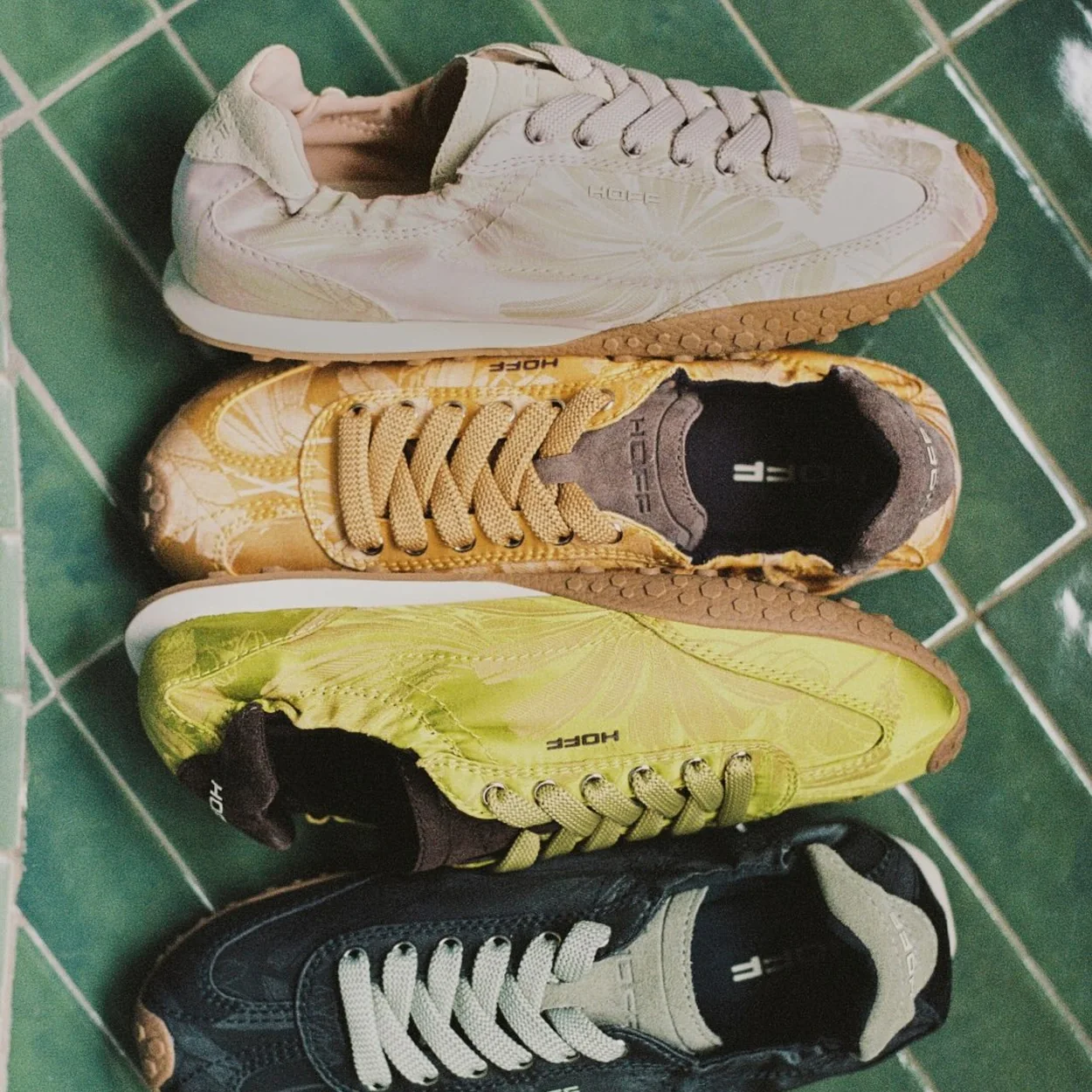 Hoff trainers in four colourways on green tiles