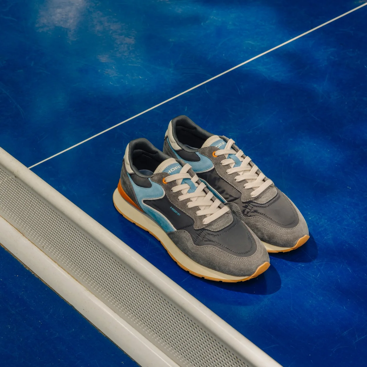 Hoff grey and blue runner trainers beside a swimming pool