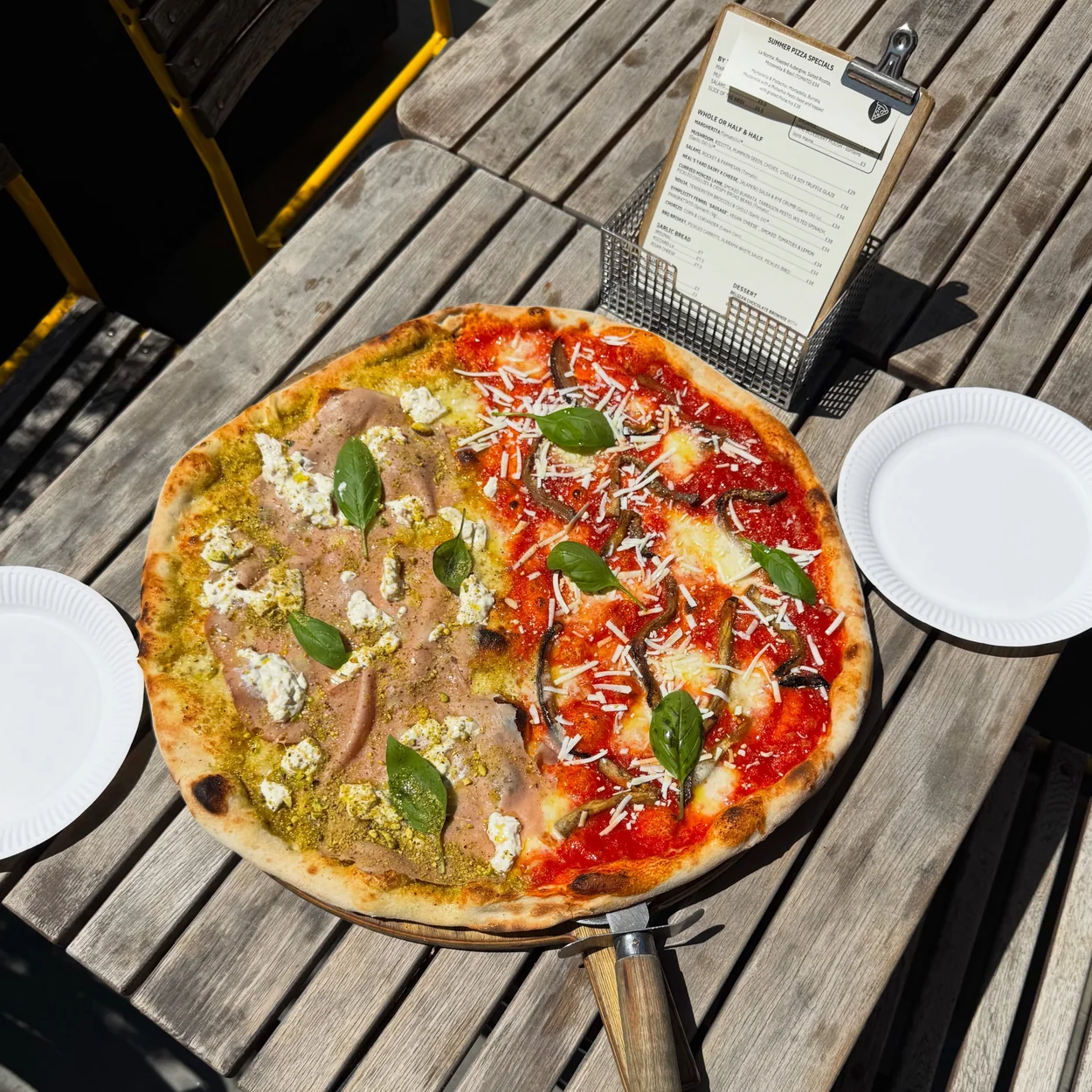 Homeslice half and half pizza on an outdoor table in Neal's Yard