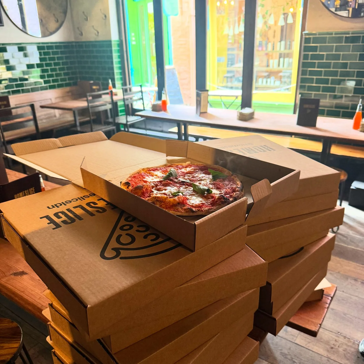 Homeslice pizza boxes stacked inside the Neal's Yard restaurant