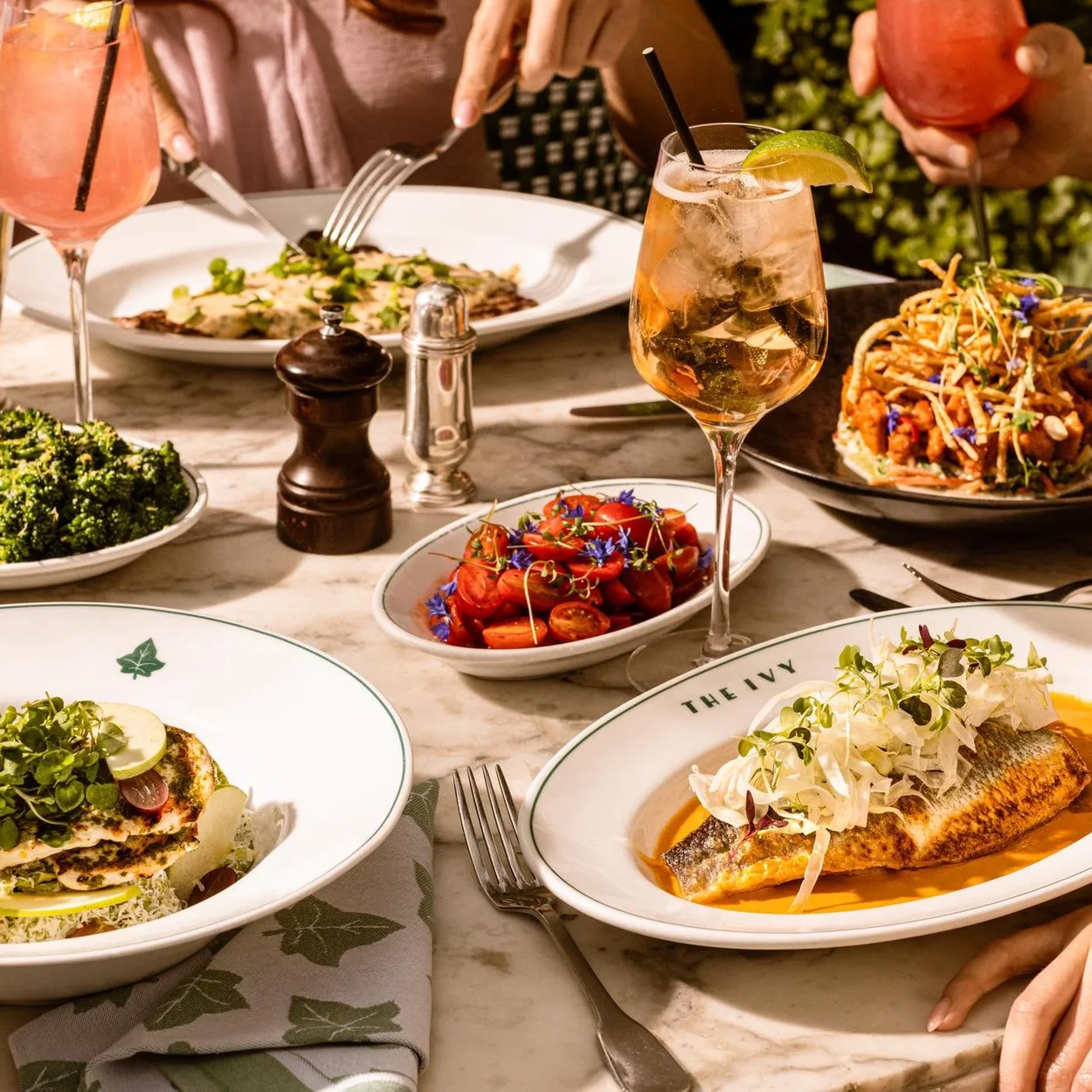 The Ivy Market Grill table of brasserie dishes with greens and tomatoes