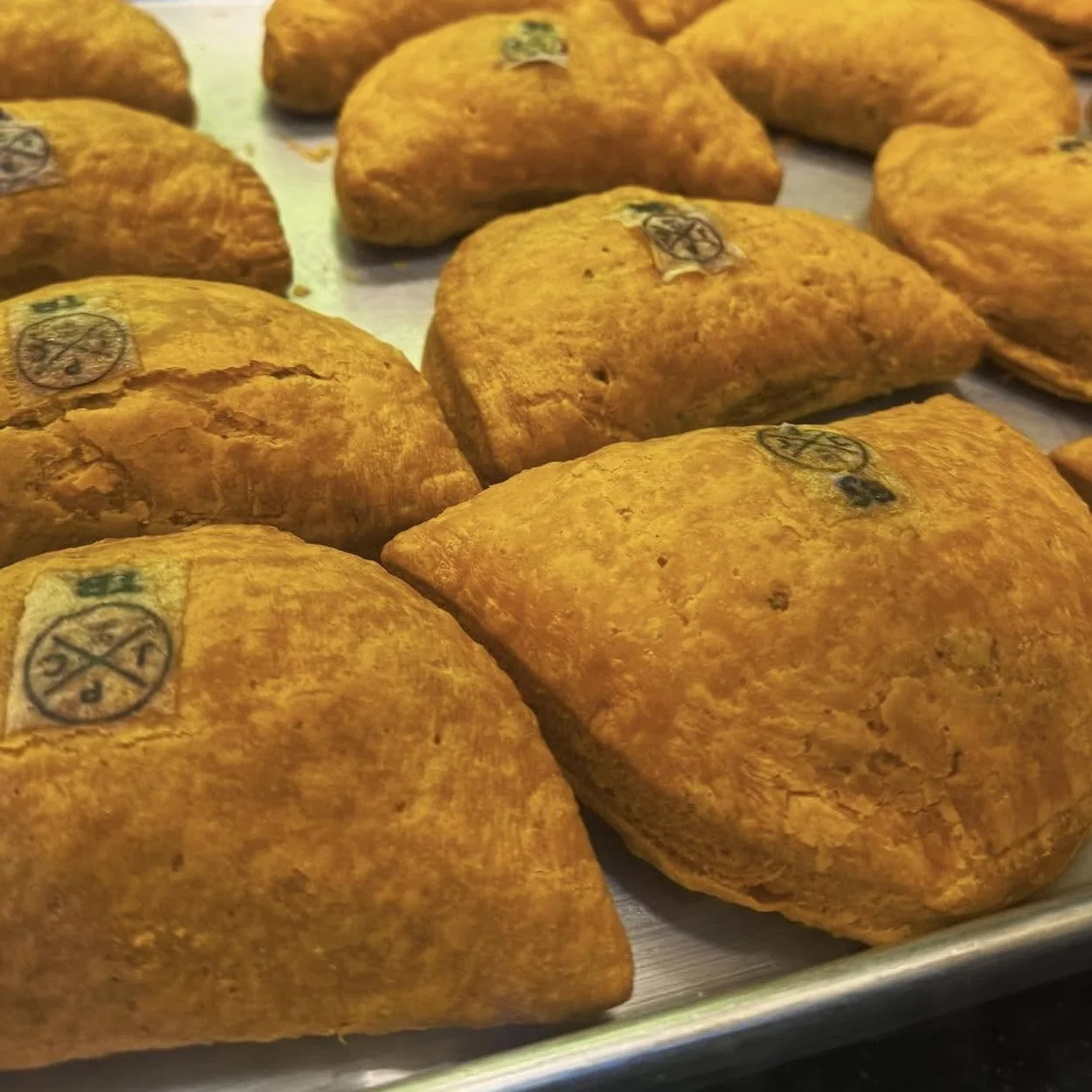 Jamaica Patty Co freshly baked Jamaican patties on a tray