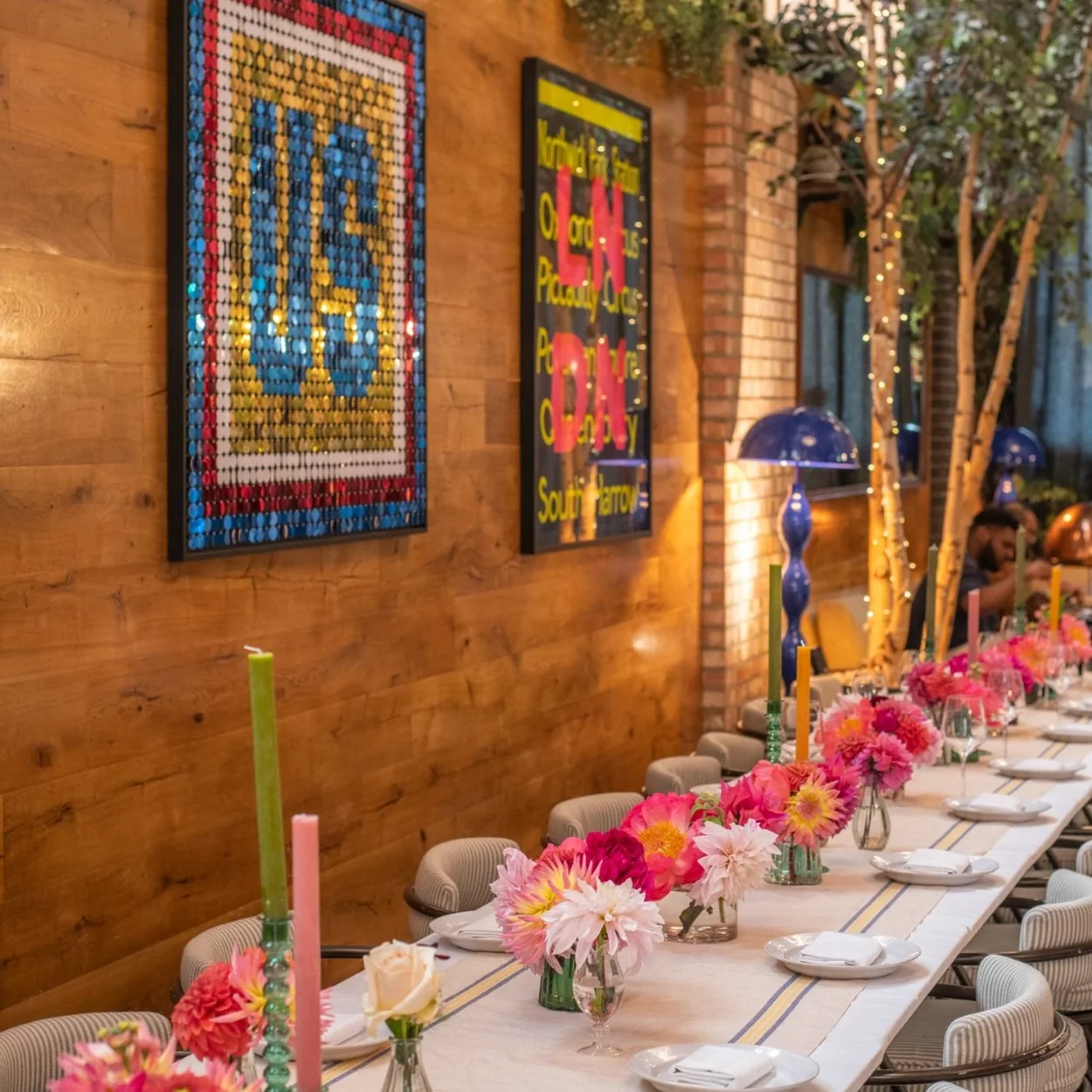Jamie Oliver Catherine St long table dressed with flowers for a group dinner