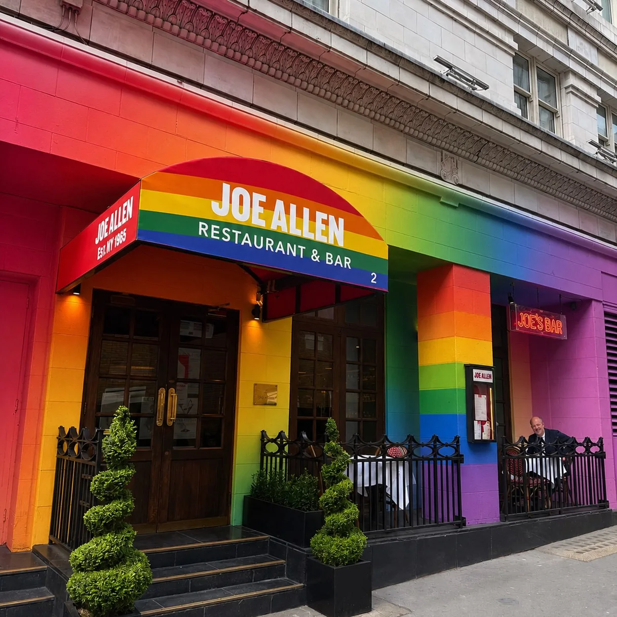 Joe Allen restaurant frontage on Burleigh Street painted in rainbow stripes