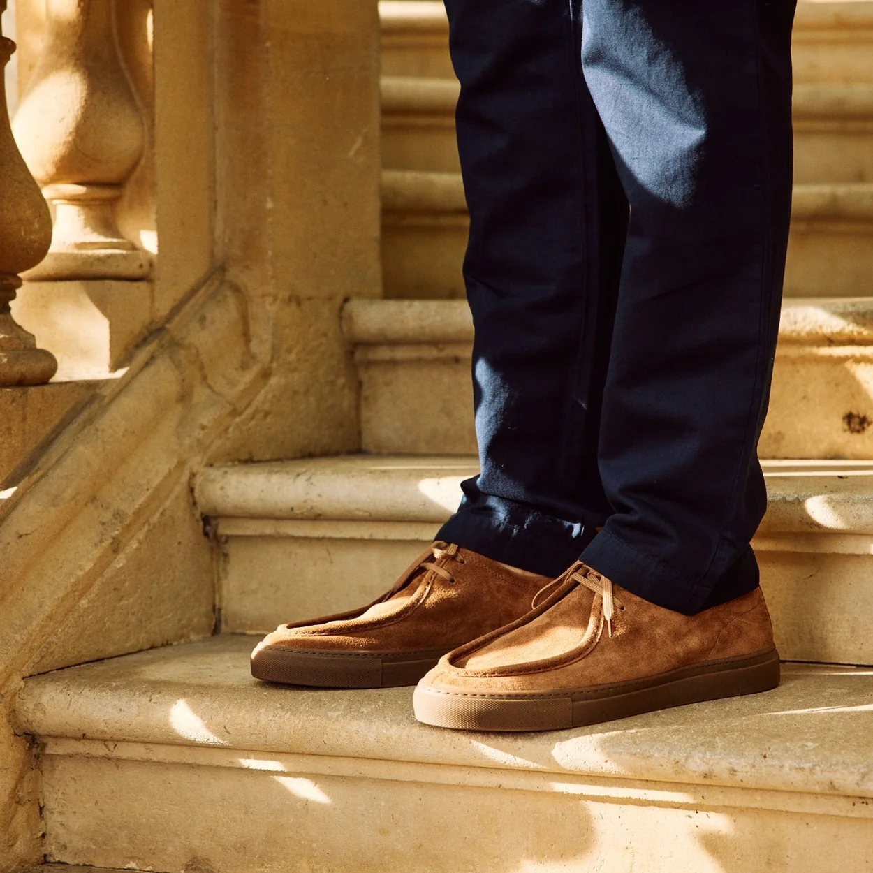 Joseph Cheaney tan suede chukka boots on stone steps