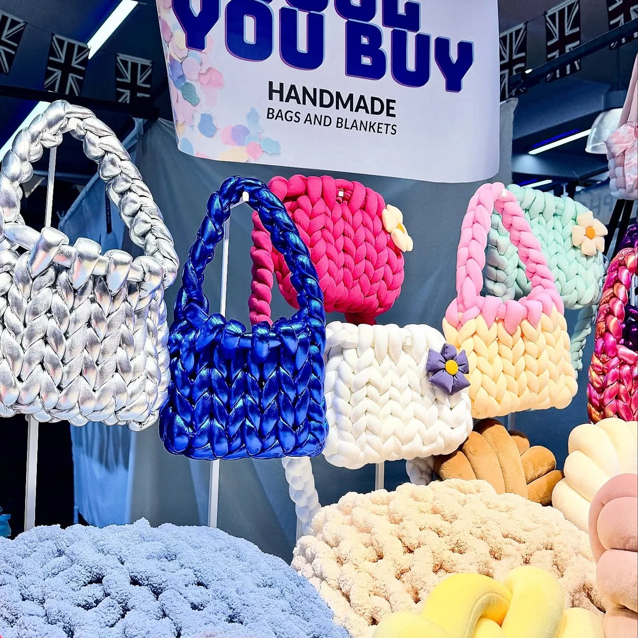 Jubilee Market handmade chunky-knit bags displayed on a craft stall