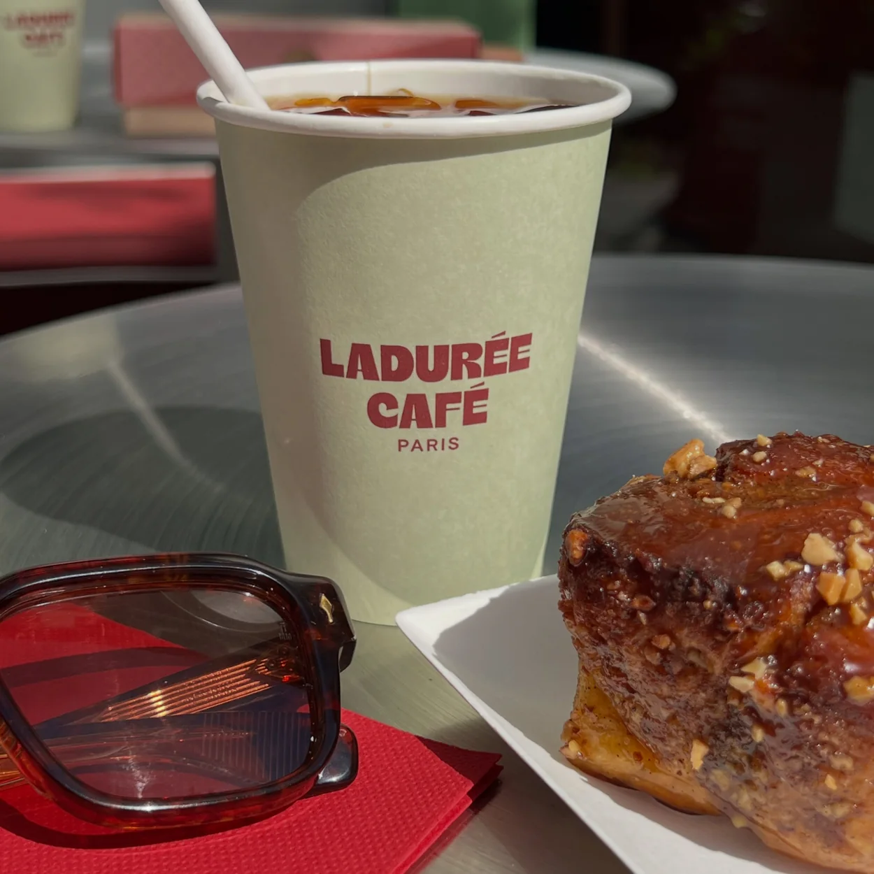 Ladurée Covent Garden iced coffee and a pastry on a cafe table