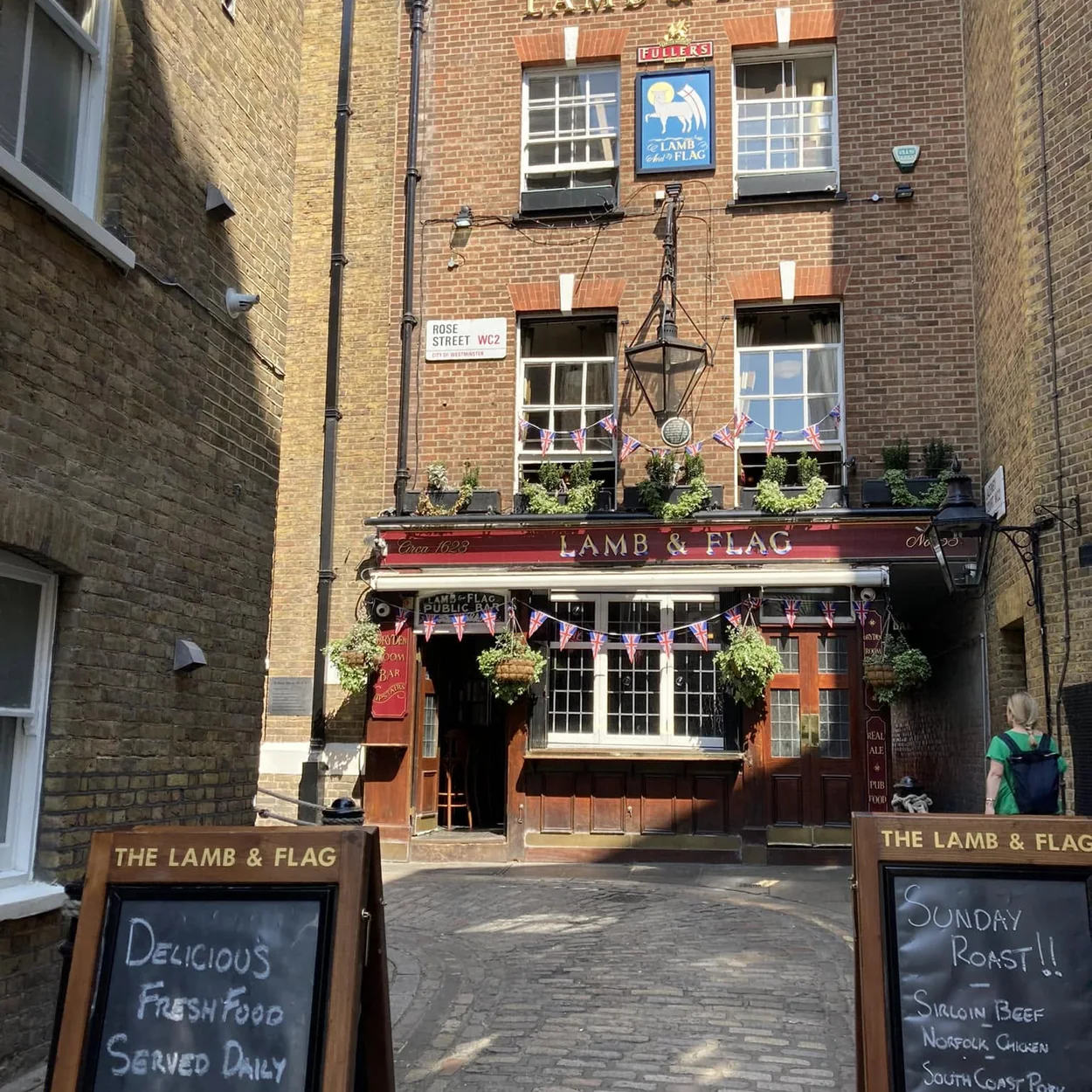 The brick frontage of the Lamb & Flag seen from the Rose Street alleyway