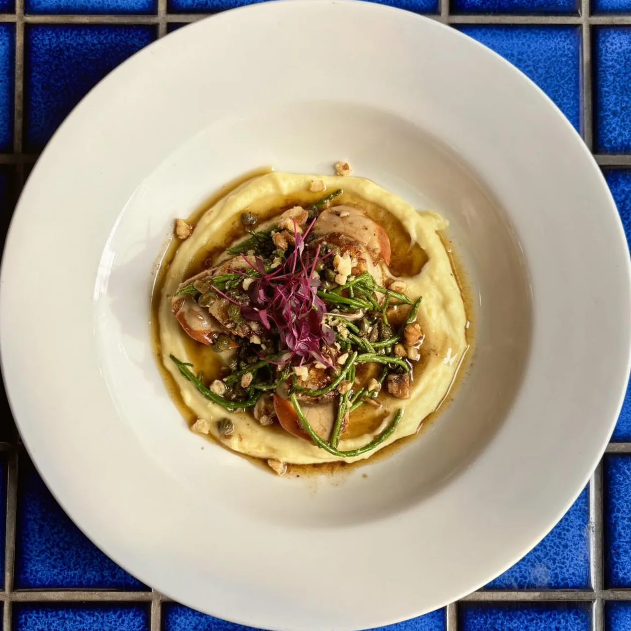 Le Beaujolais seasonal plate served on a blue tiled table