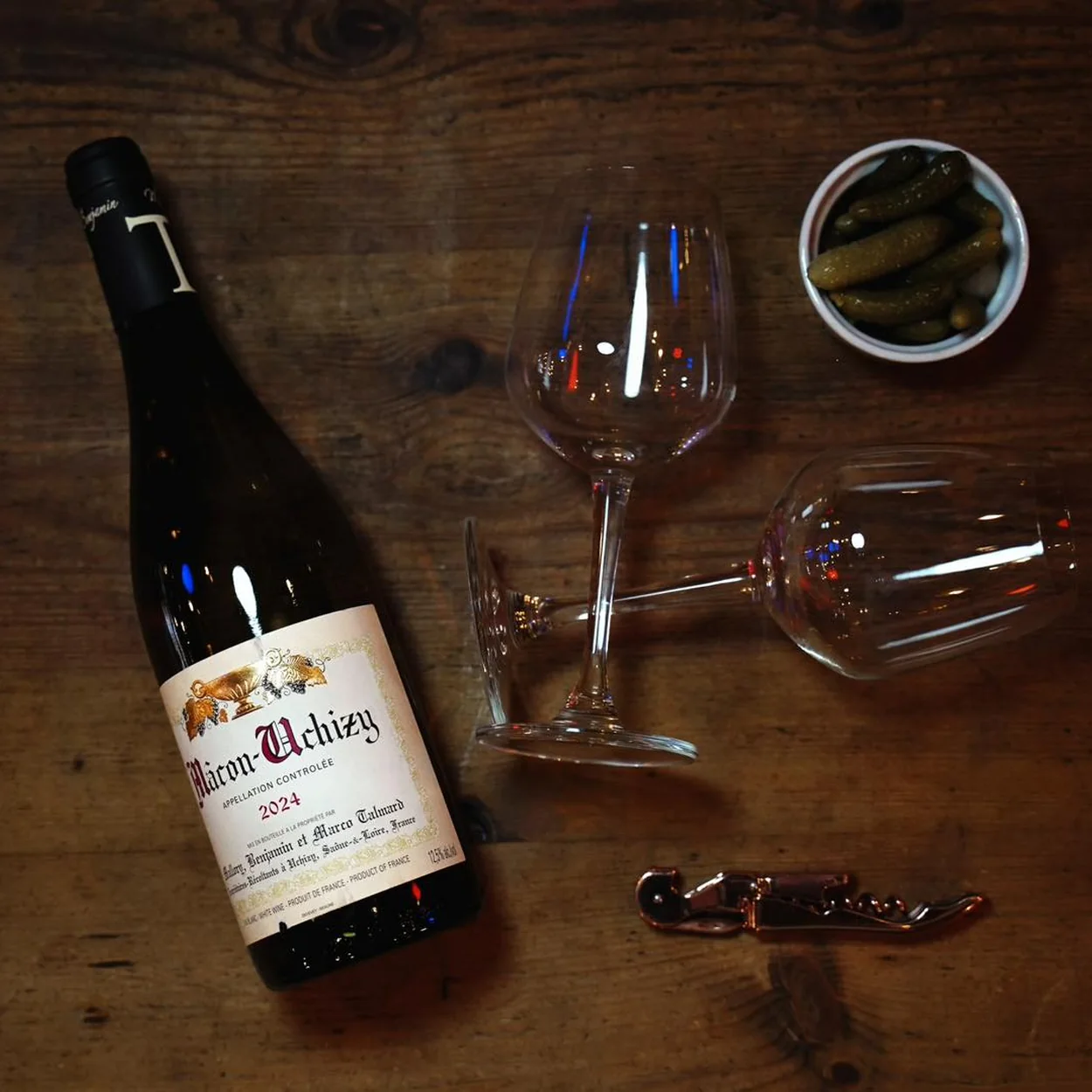 Le Beaujolais French white wine with glasses on a wooden table