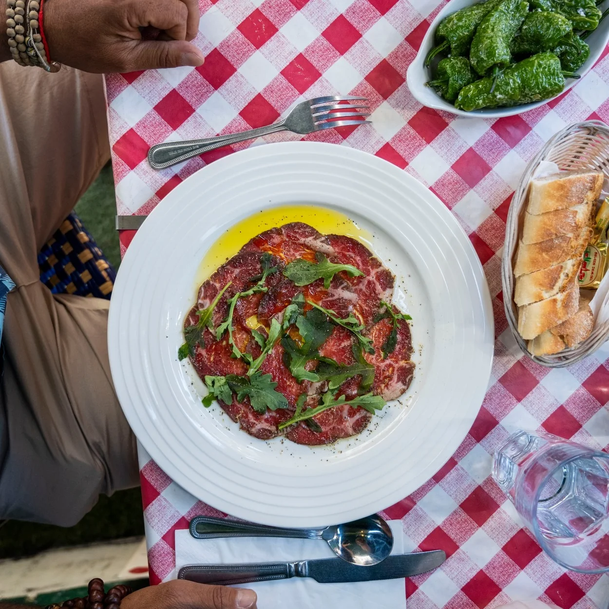 Le Garrick beef carpaccio with rocket on a gingham tablecloth