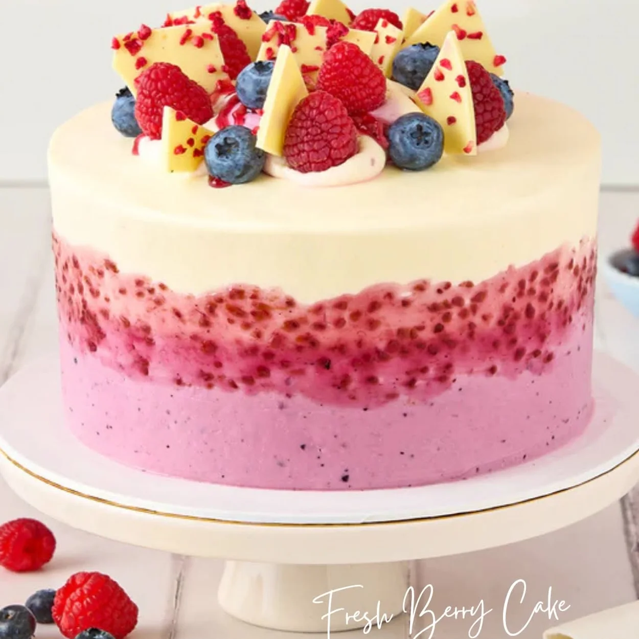 Lola's Cupcakes fresh berry layer cake on a cake stand