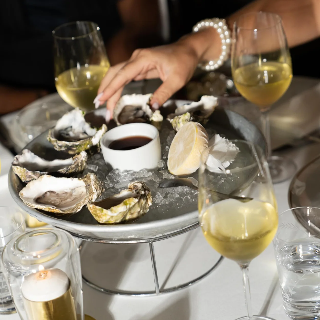 Louie oysters on ice with glasses of white wine