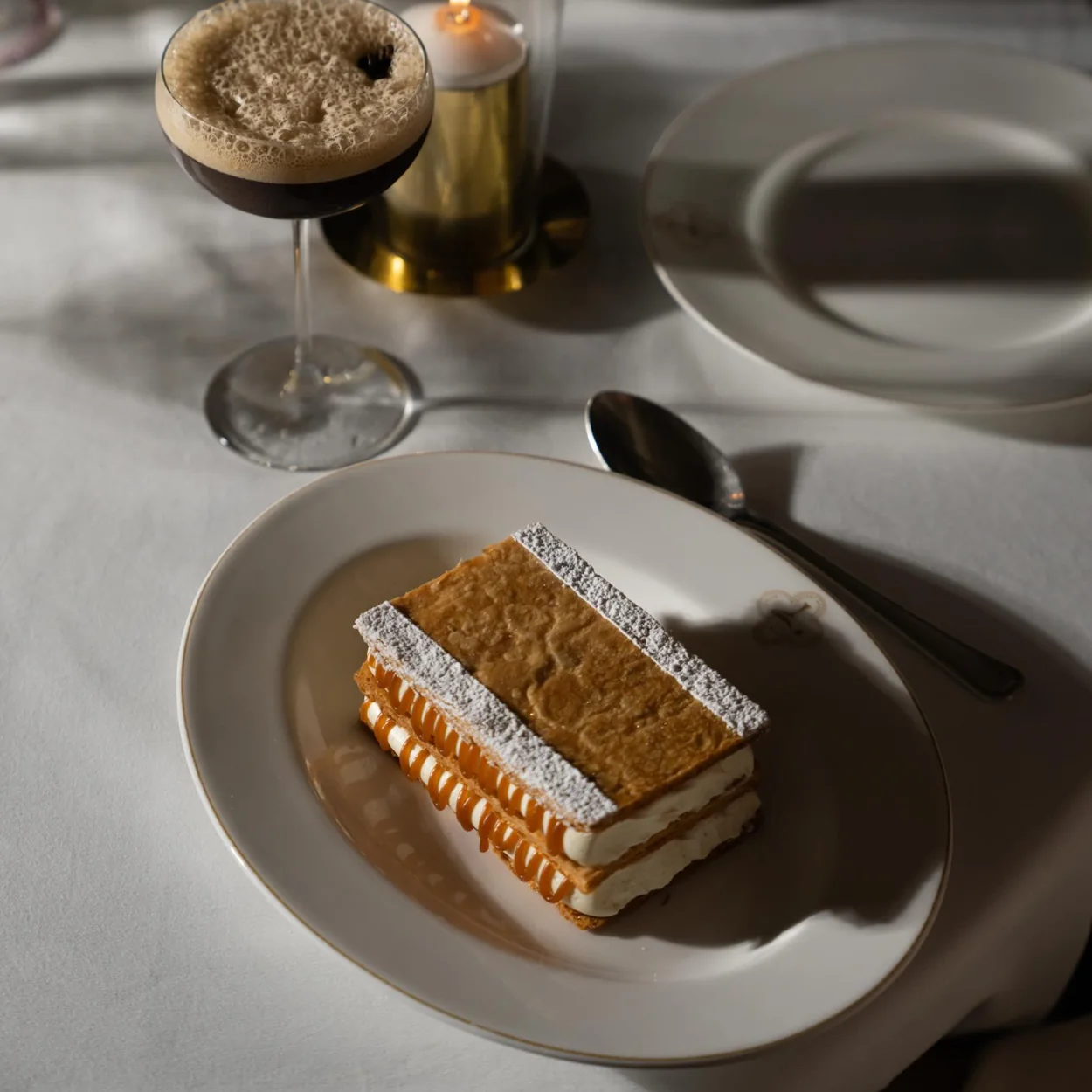 Louie mille-feuille dessert and candlelit table setting