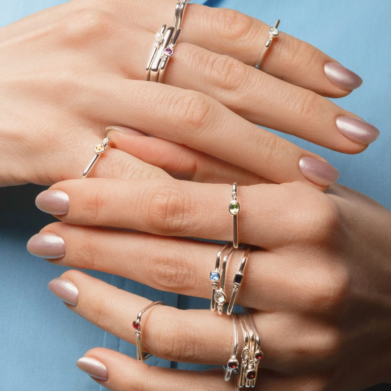 Mejuri stacked gold and silver rings worn on both hands