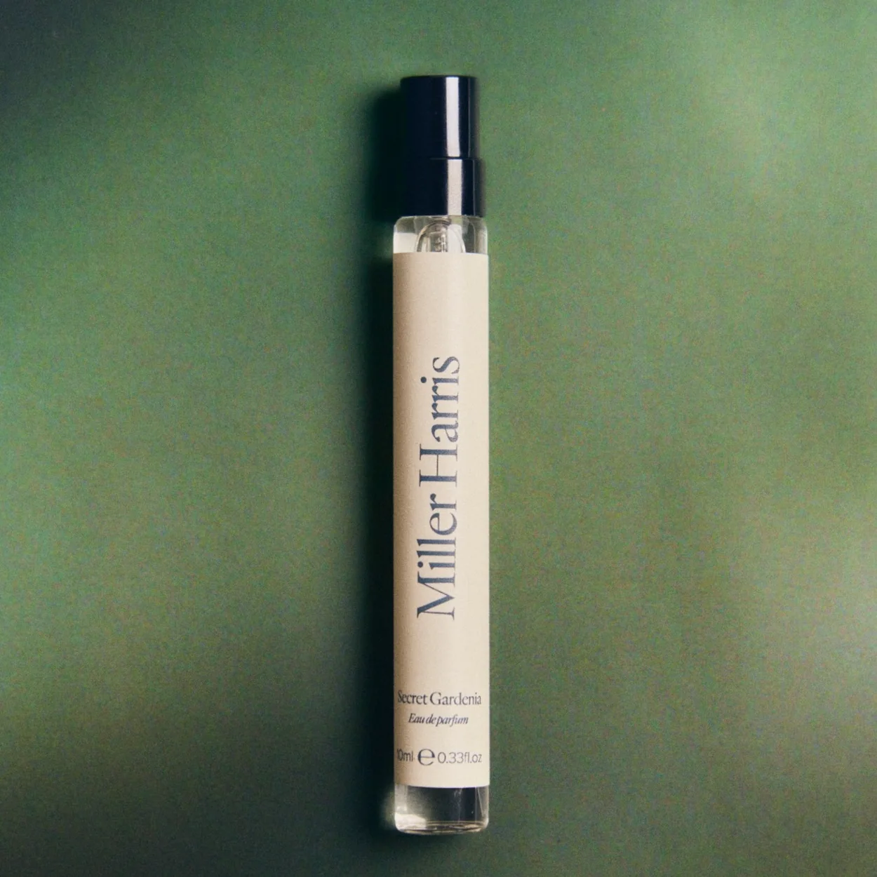 Miller Harris 10ml travel fragrance on a green background