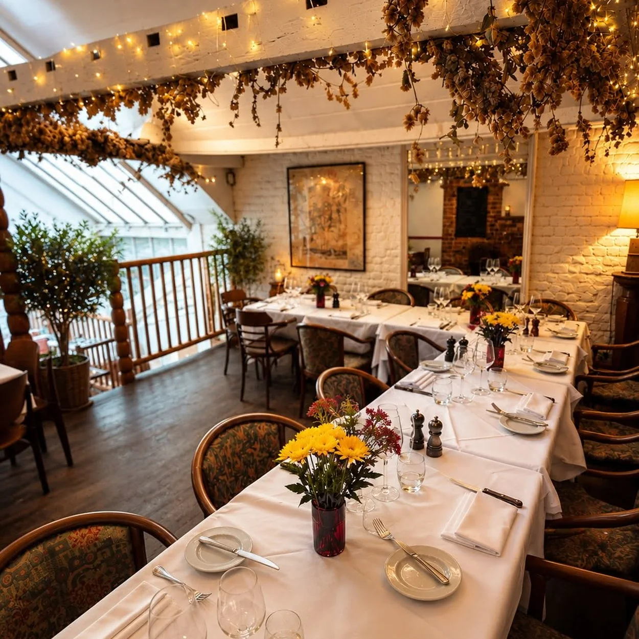Mon Plaisir dining room laid for dinner beneath the skylight