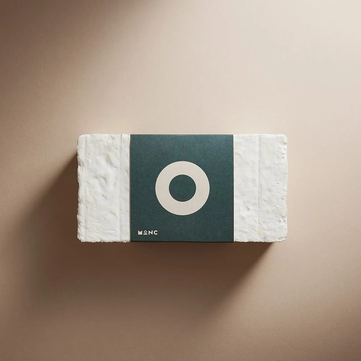 MONC mycelium frame packaging with green logo card