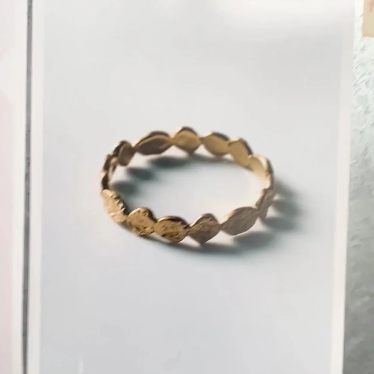 Monica Vinader gold bangle photographed on a white board