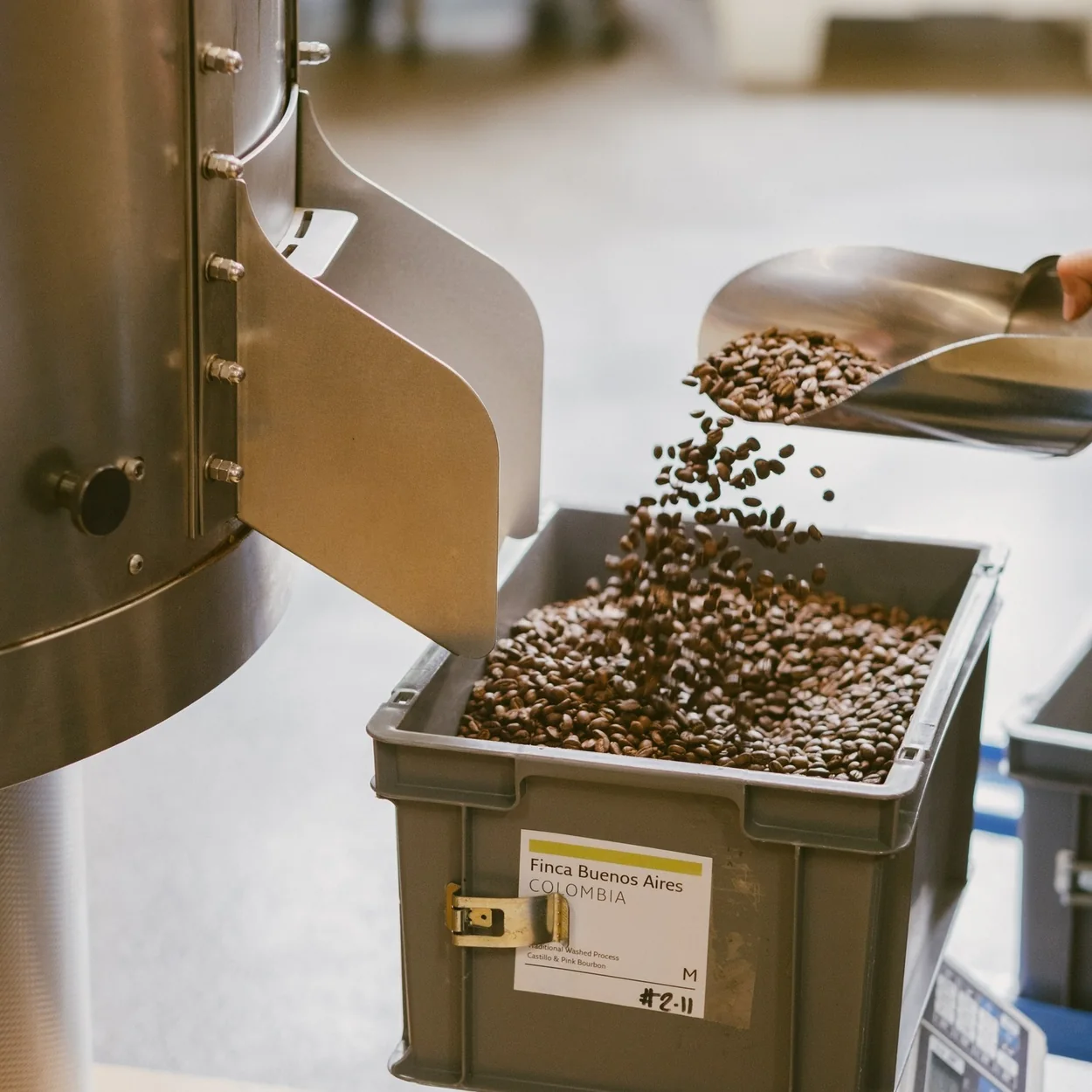 Monmouth Coffee freshly roasted beans pouring from the roaster