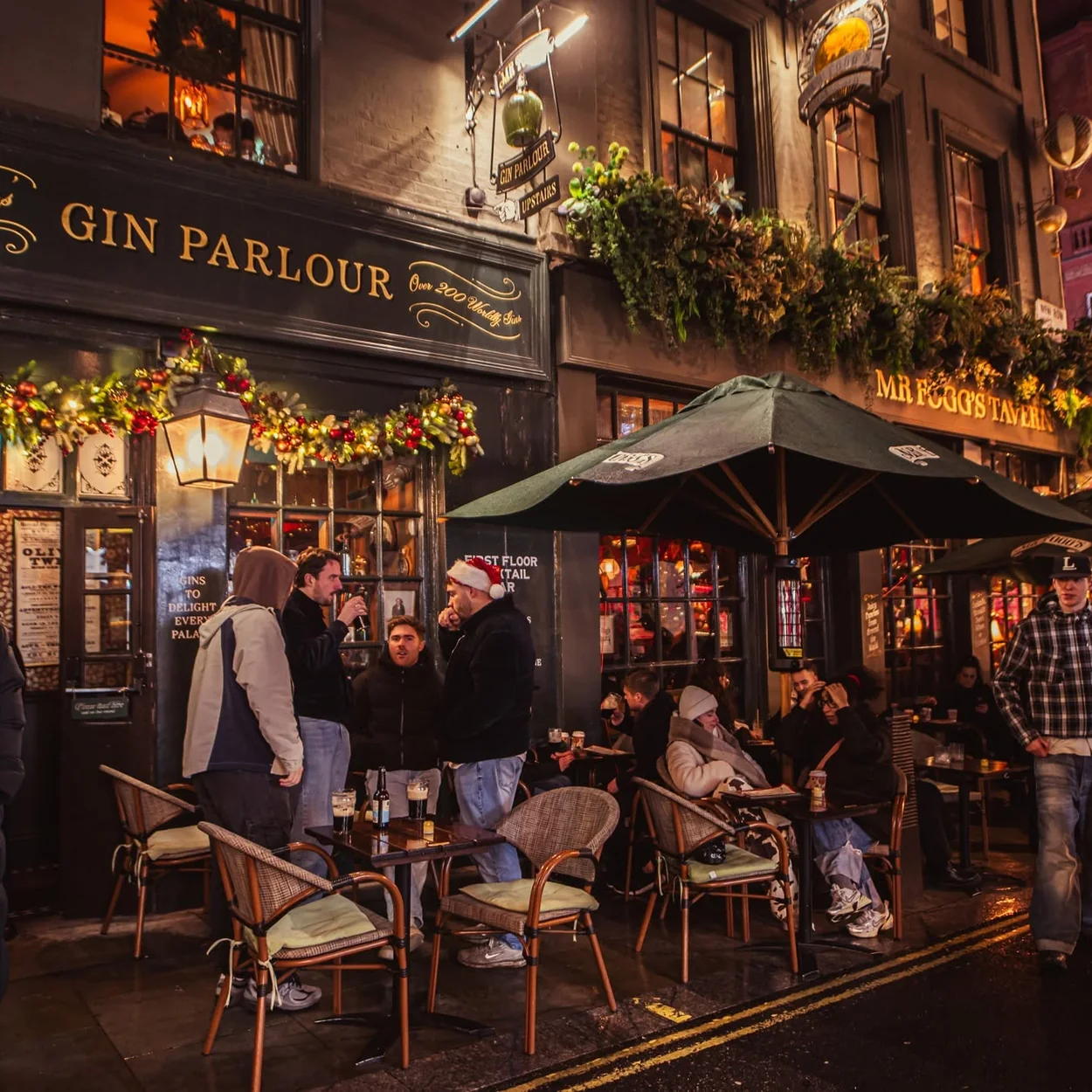 Mr Fogg's Tavern and Gin Parlour corner frontage with pavement seating at night