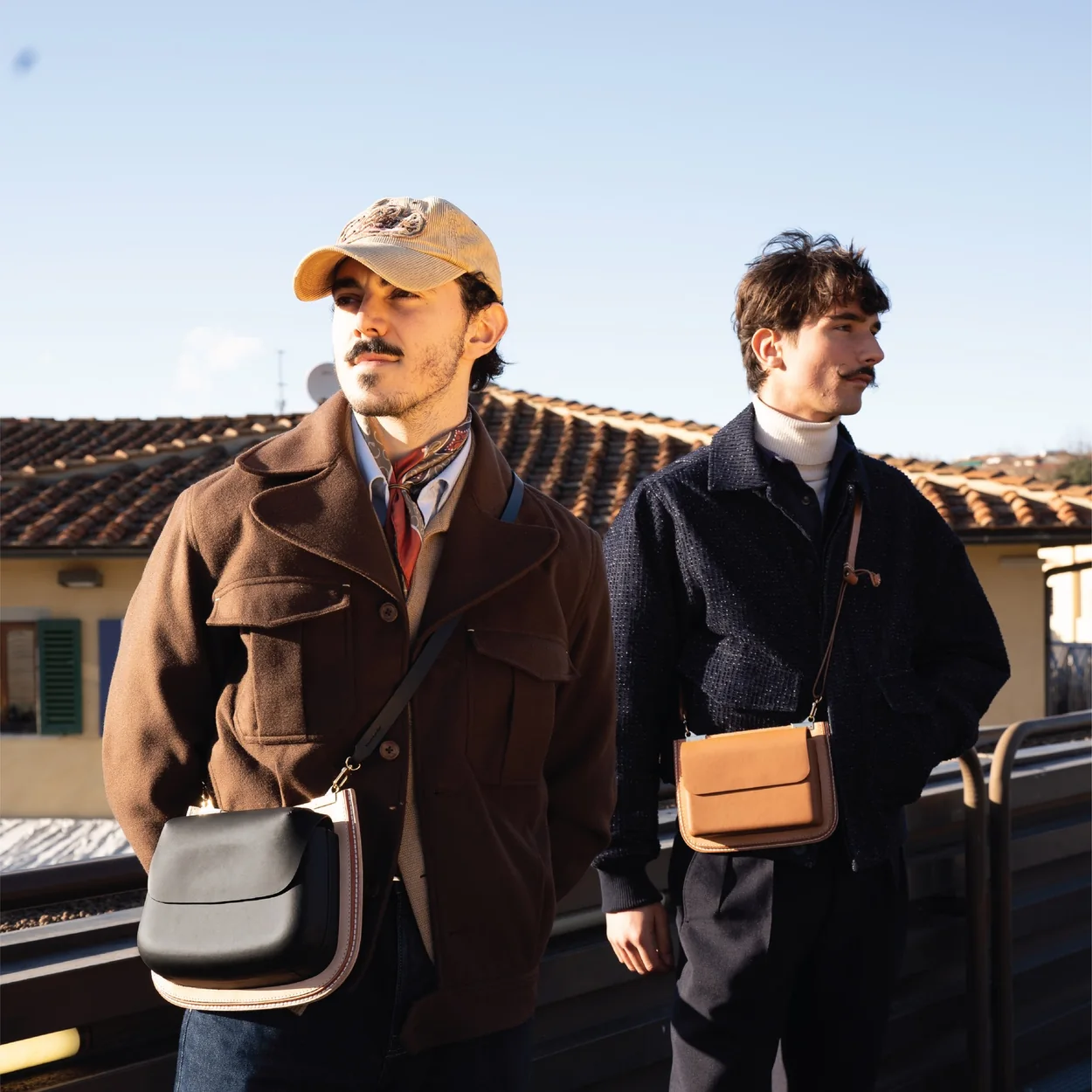 Nappa Dori leather crossbody bags worn by two men outdoors