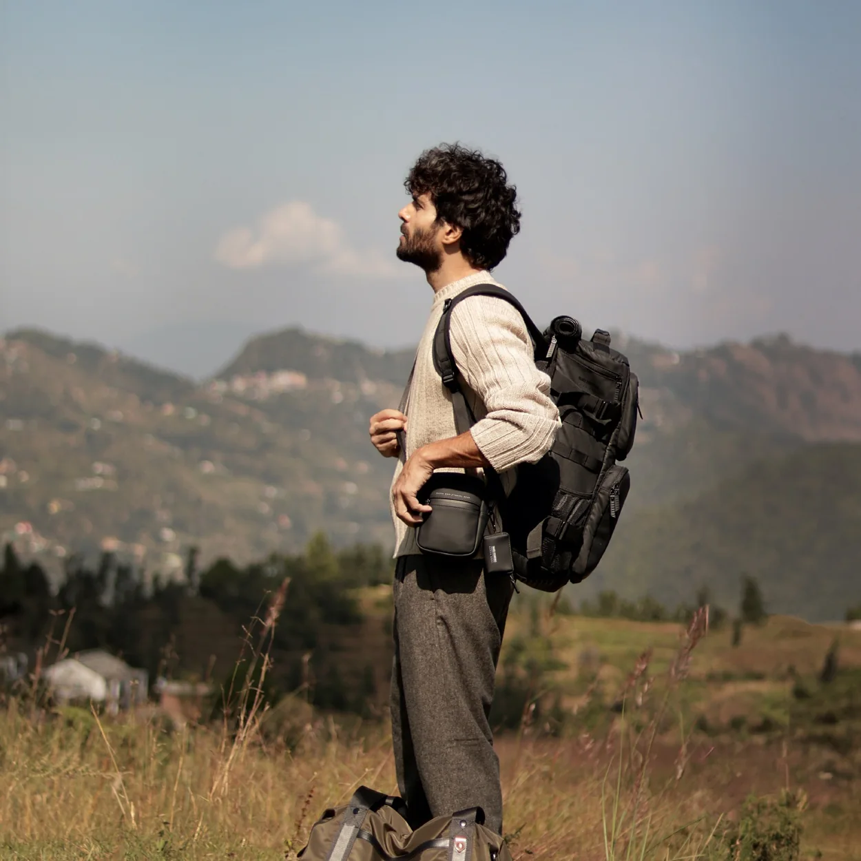 Nappa Dori leather-trimmed backpack and duffel on a hillside walk