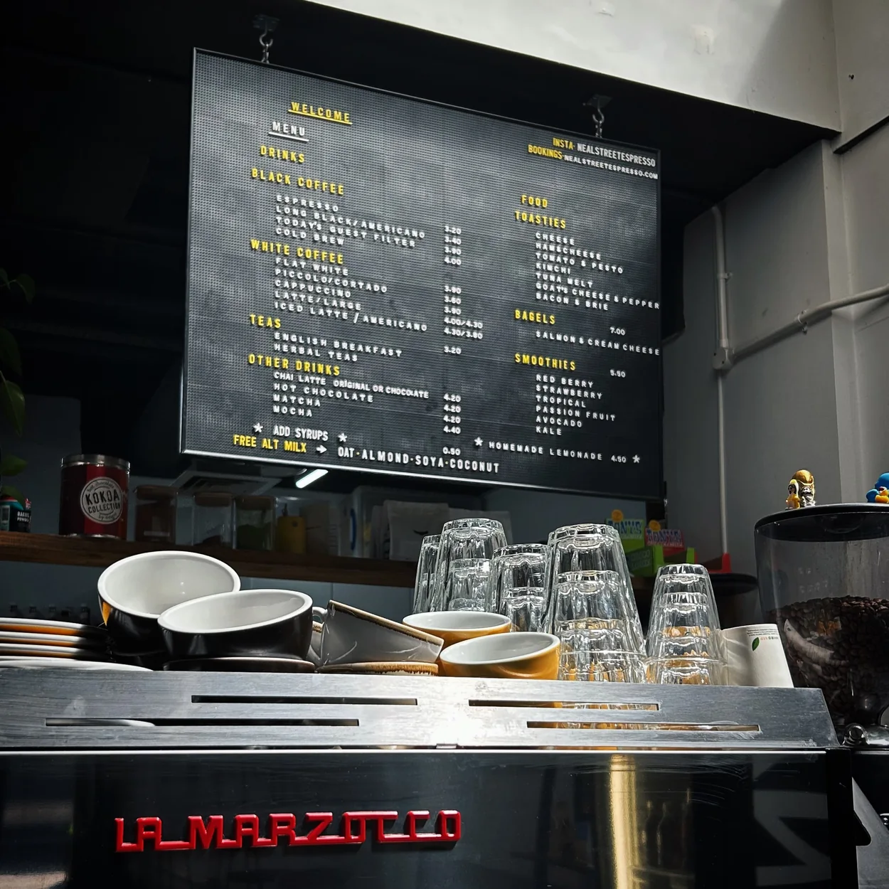 Neal Street Espresso La Marzocco machine and menu board at the counter
