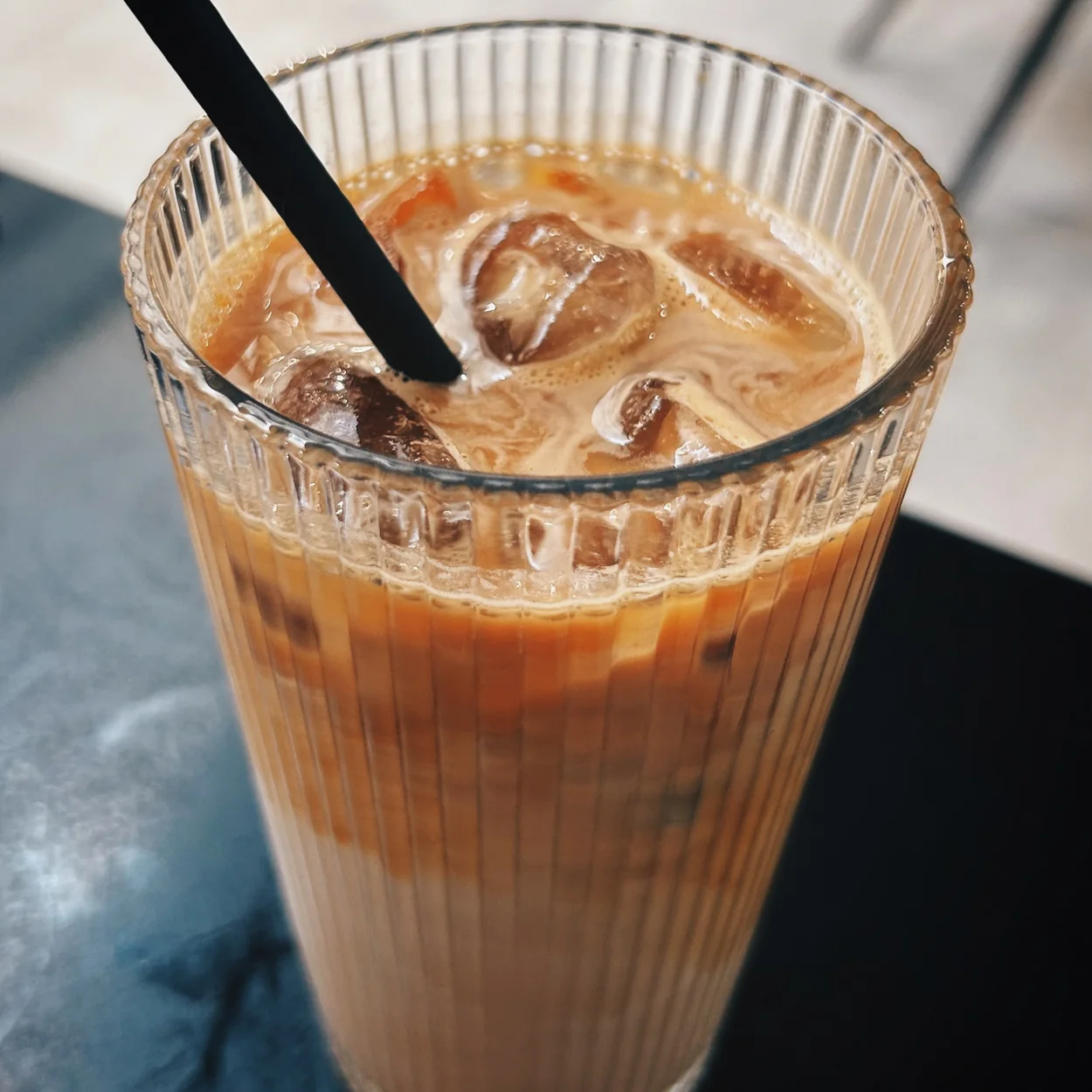 Neal Street Espresso iced latte in a ribbed glass