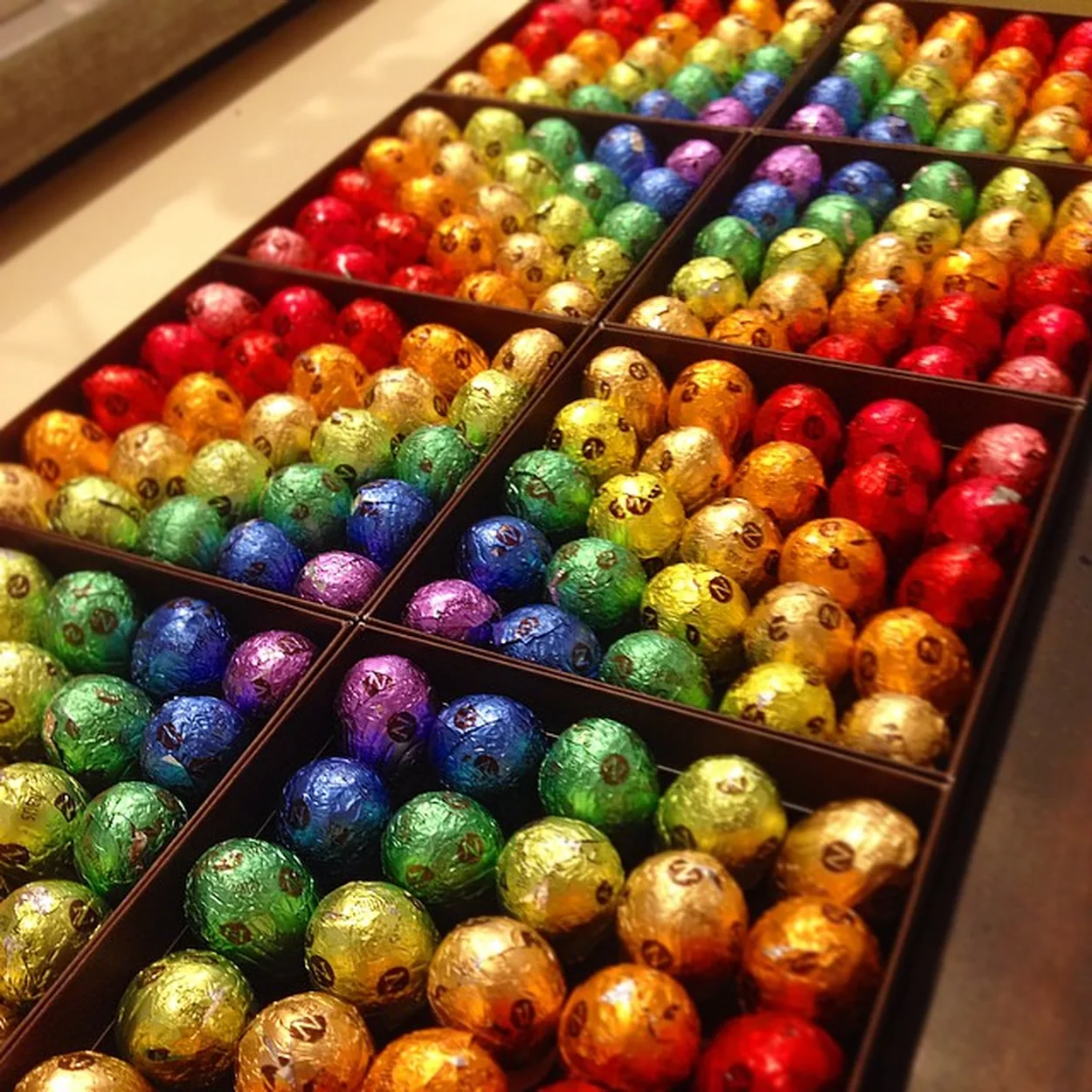 Neuhaus foil-wrapped chocolates in colourful rows