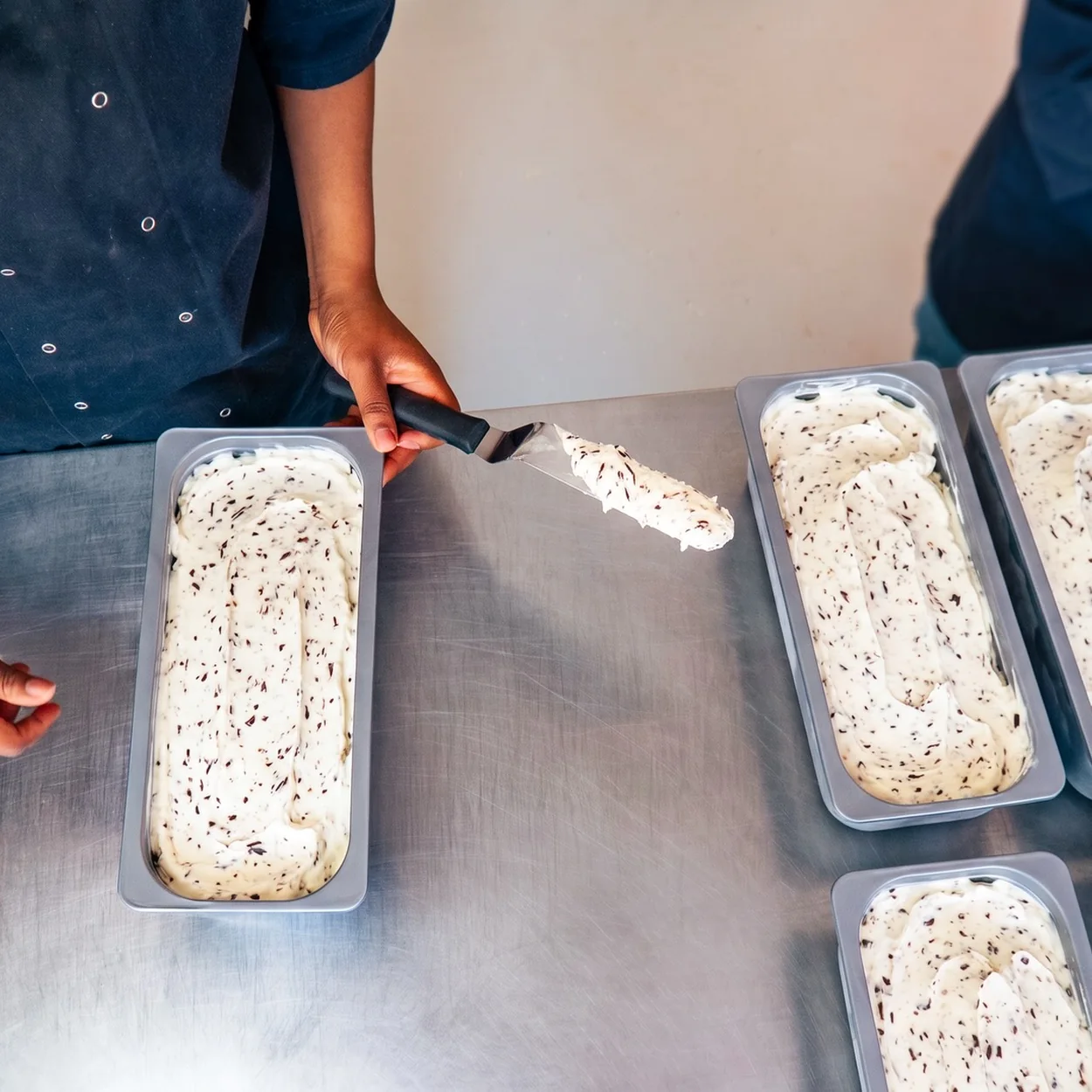 Oliphant's Ice Cream and Bakery team filling tubs of handmade ice cream
