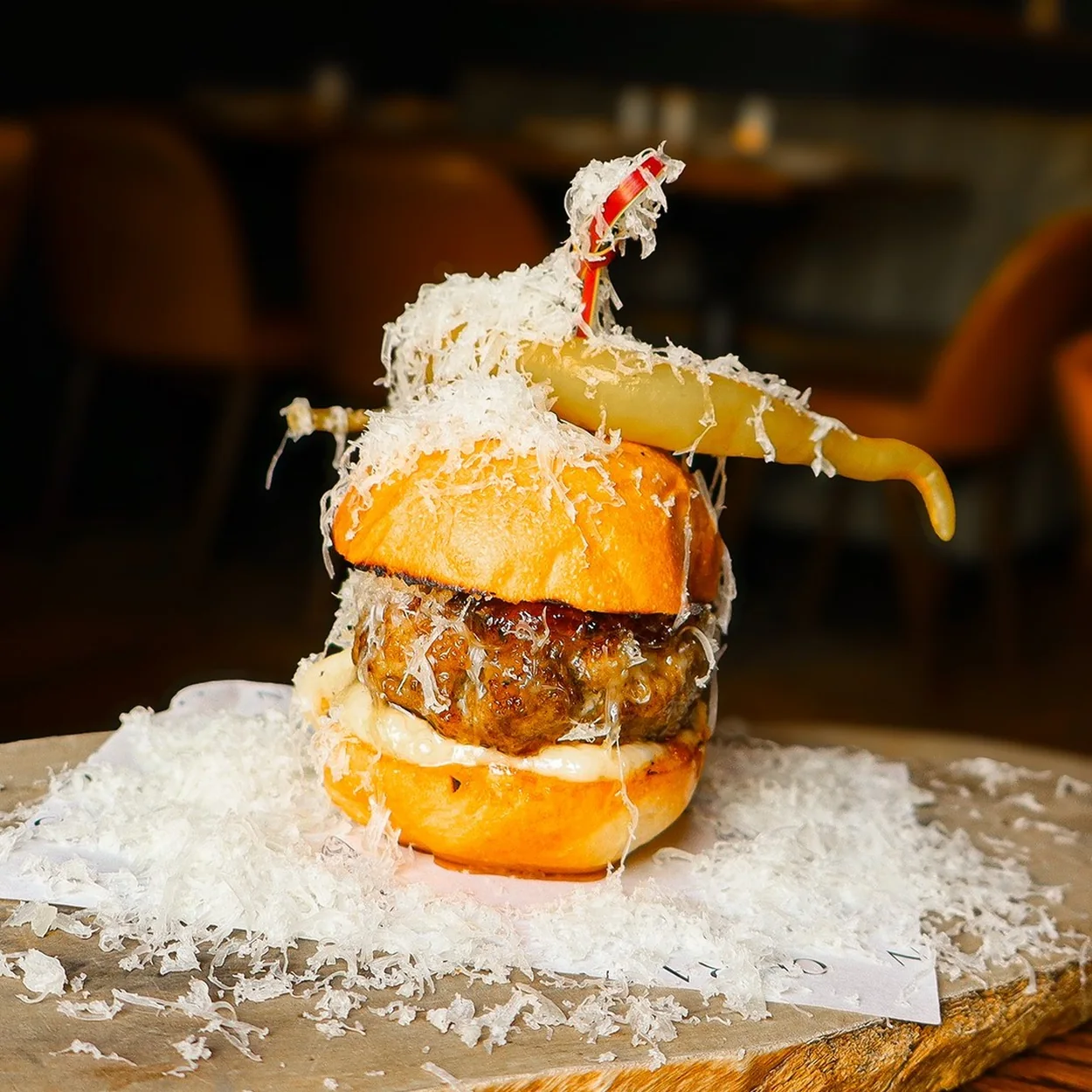 The Opera Tavern signature mini burger topped with shaved cheese