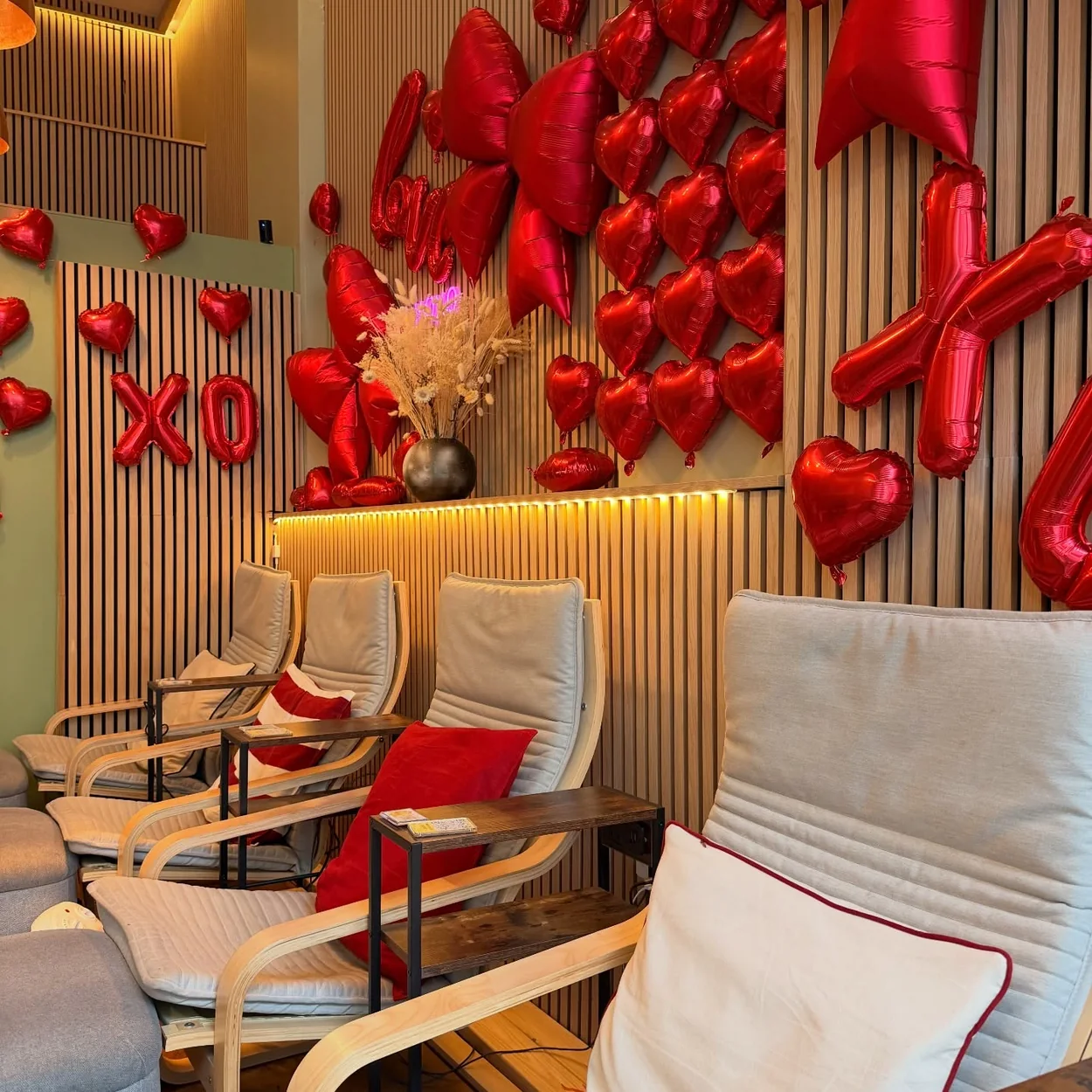 Opulence Thai Spa reception lounge with reclining chairs and wood-slat walls