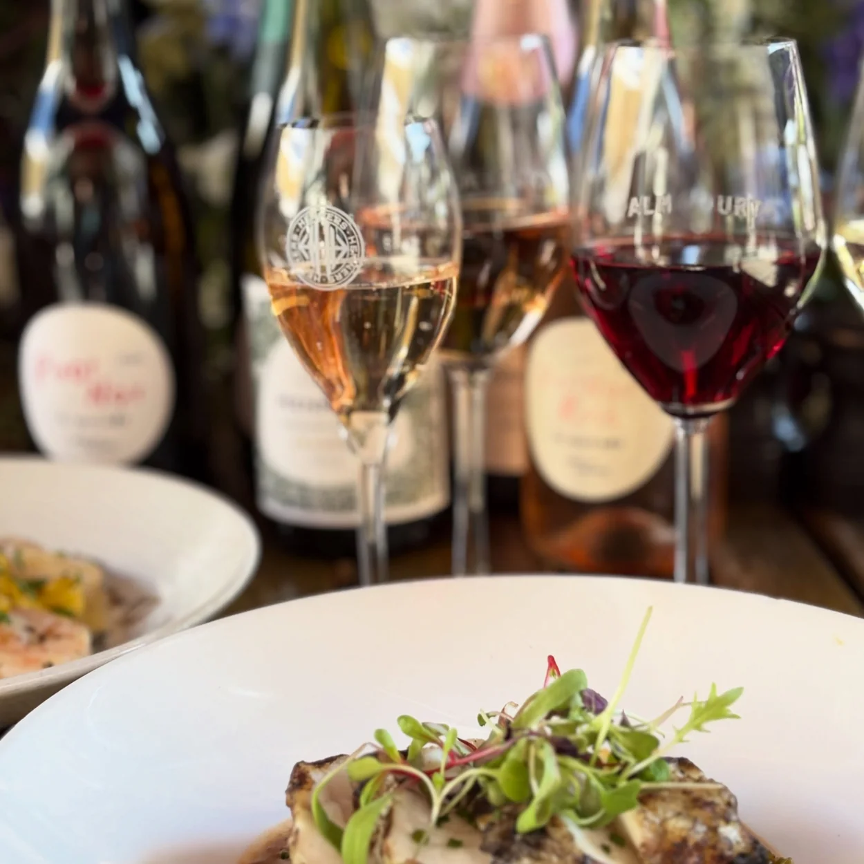Palm Court Brasserie steak in peppercorn sauce with wine glasses behind
