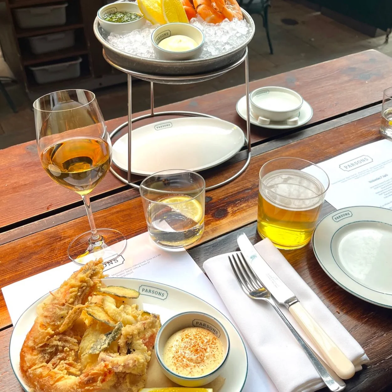 Parsons fried fish and seafood platter with a glass of white wine