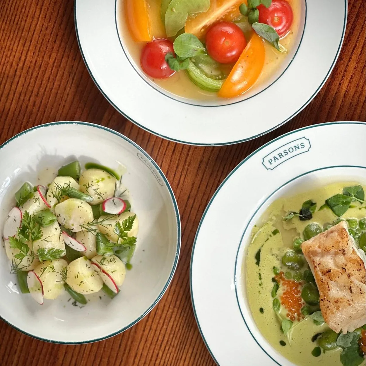 Parsons seasonal seafood plates and tomato salad on the table