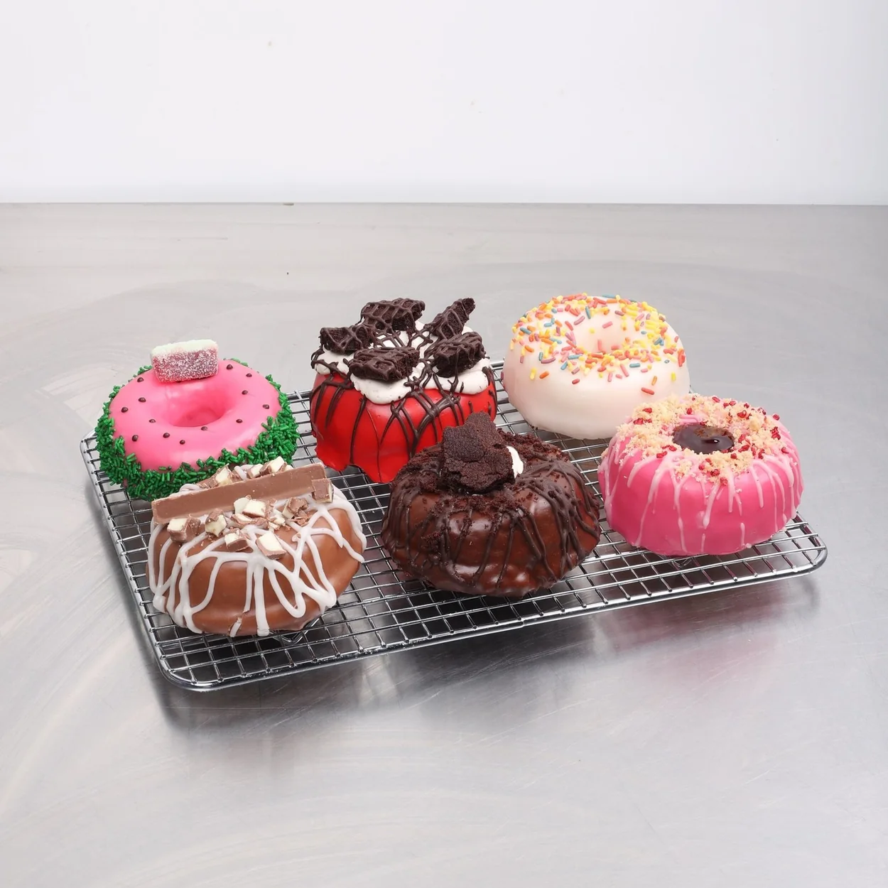 Rodeo Doughnuts selection of topped doughnuts on a cooling rack